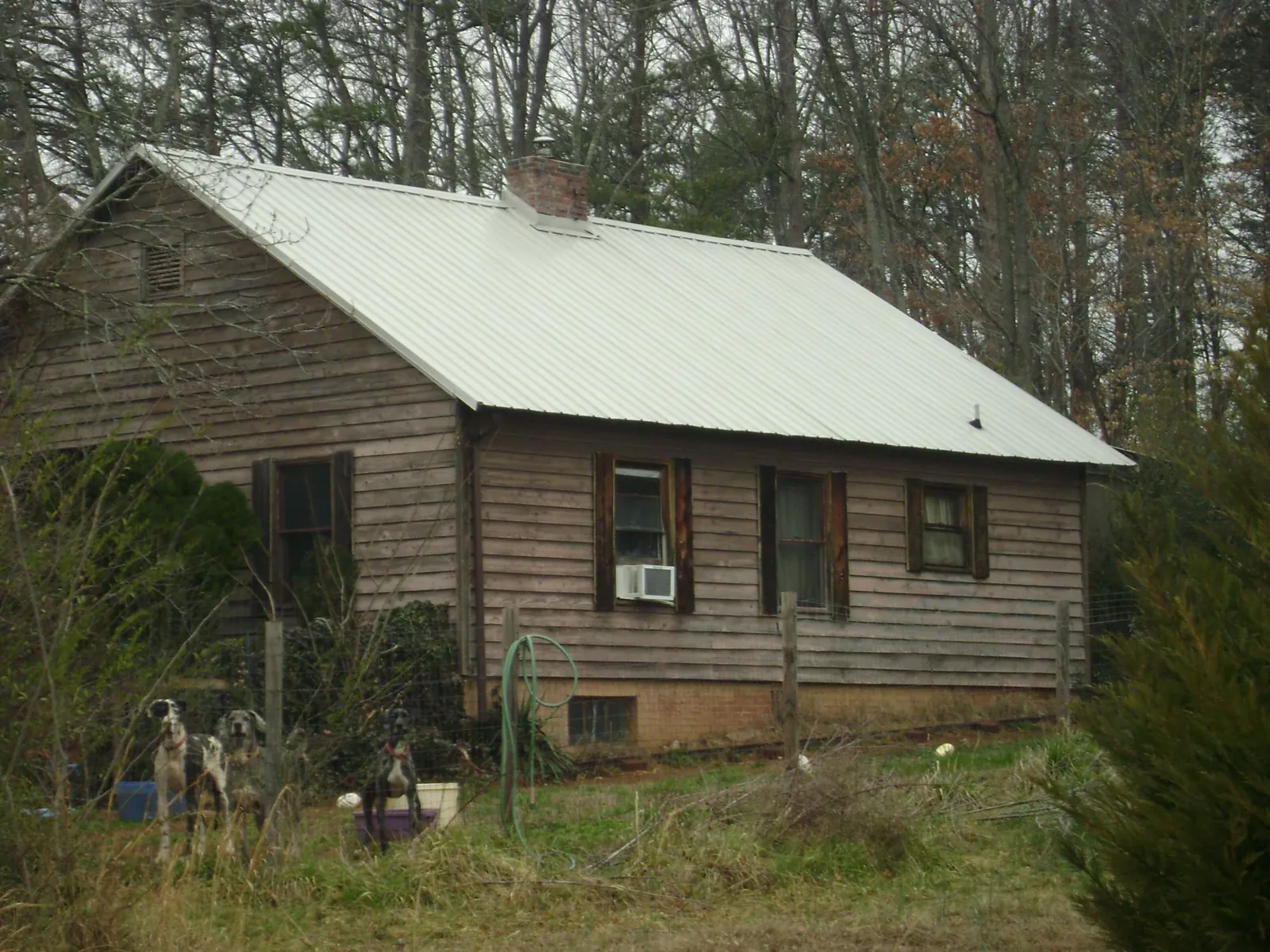 White metal roof on an old wood sided farmhouse, from a Metal Roof Installation job in Heyburn